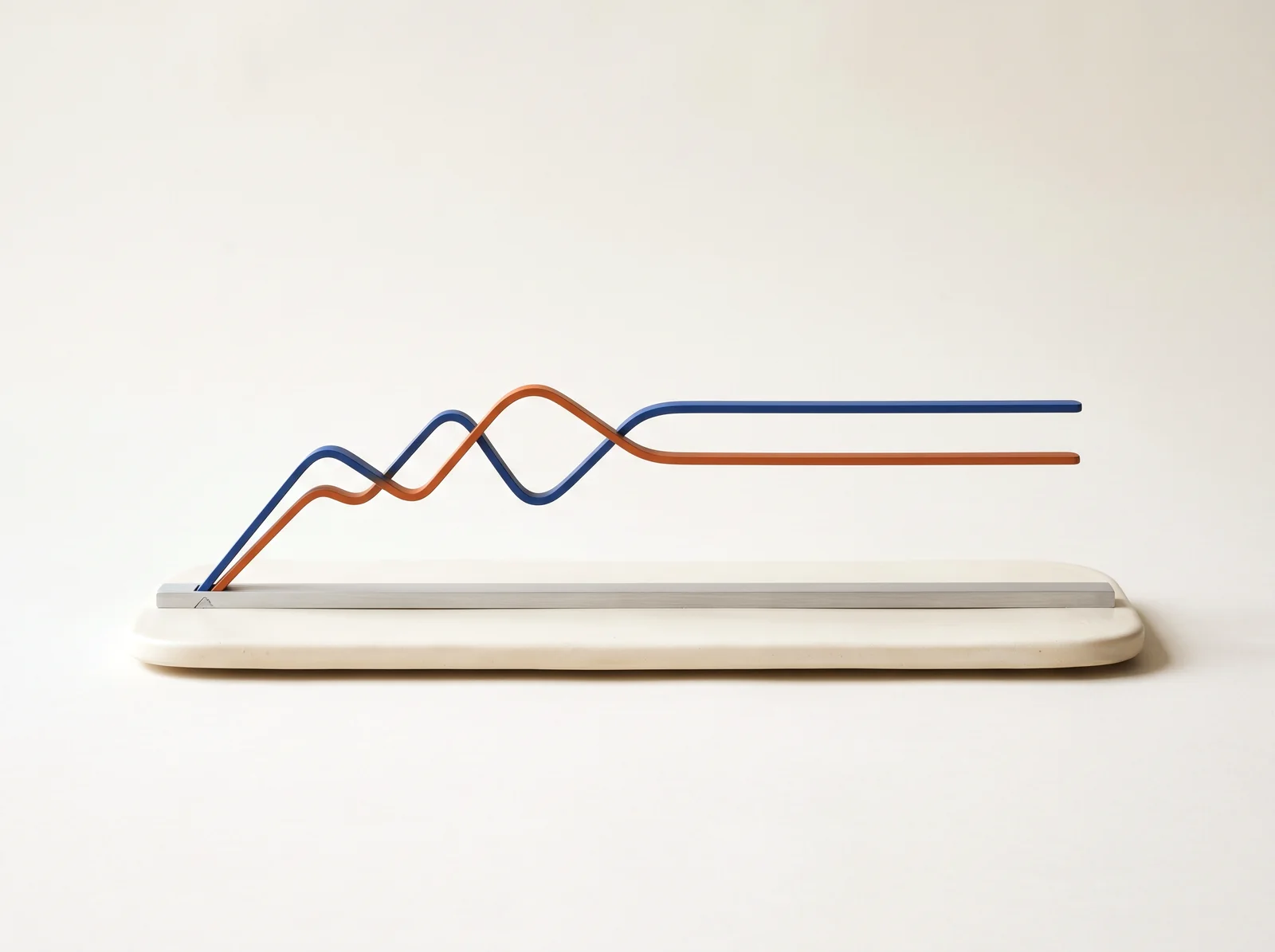 Two thin metal ribbons, one cobalt and one burnt orange, rising from an ivory slab, jostling at the left and settling parallel at the right.
